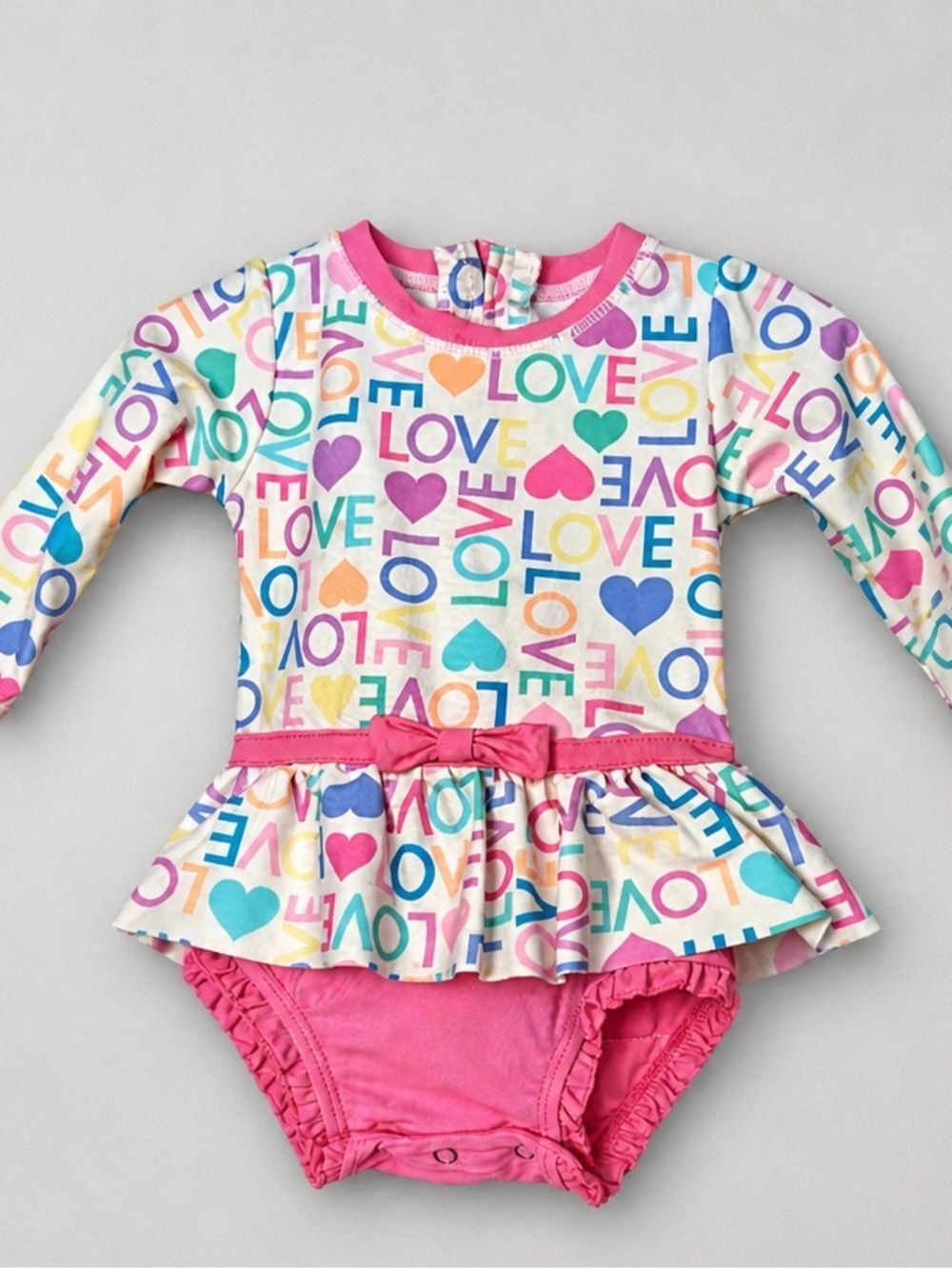 Ruffle Butts pink Love print ruffle bottom one piece rash guard swim-flaw